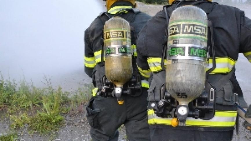 Firefighters operating a fire hose.