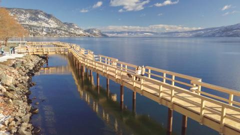 Pier over water. There is a rocky shore next to the pier.