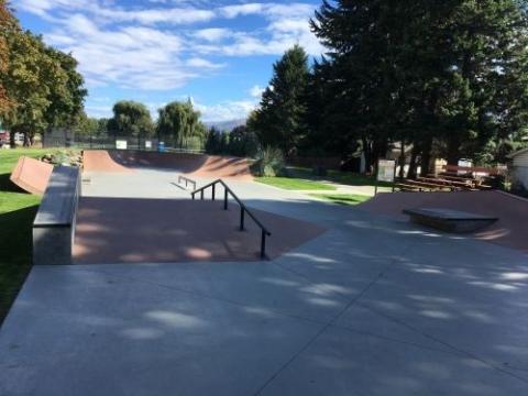 Section of skate park. There are some rails, ramps and obstacles.