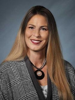 Councillor Alena Glasman headshot. There is a smiling woman in a striped blouse.