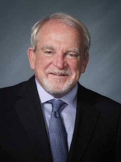 Councillor Randey Brophy headshot. There is a smiling man in a suit and tie.