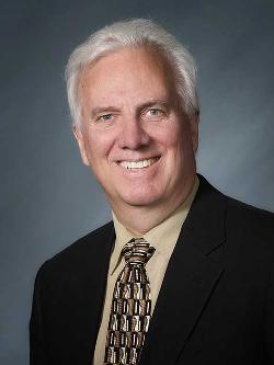 Councillor Rick Ingram headshot. There is a smiling man in a suit and tie.